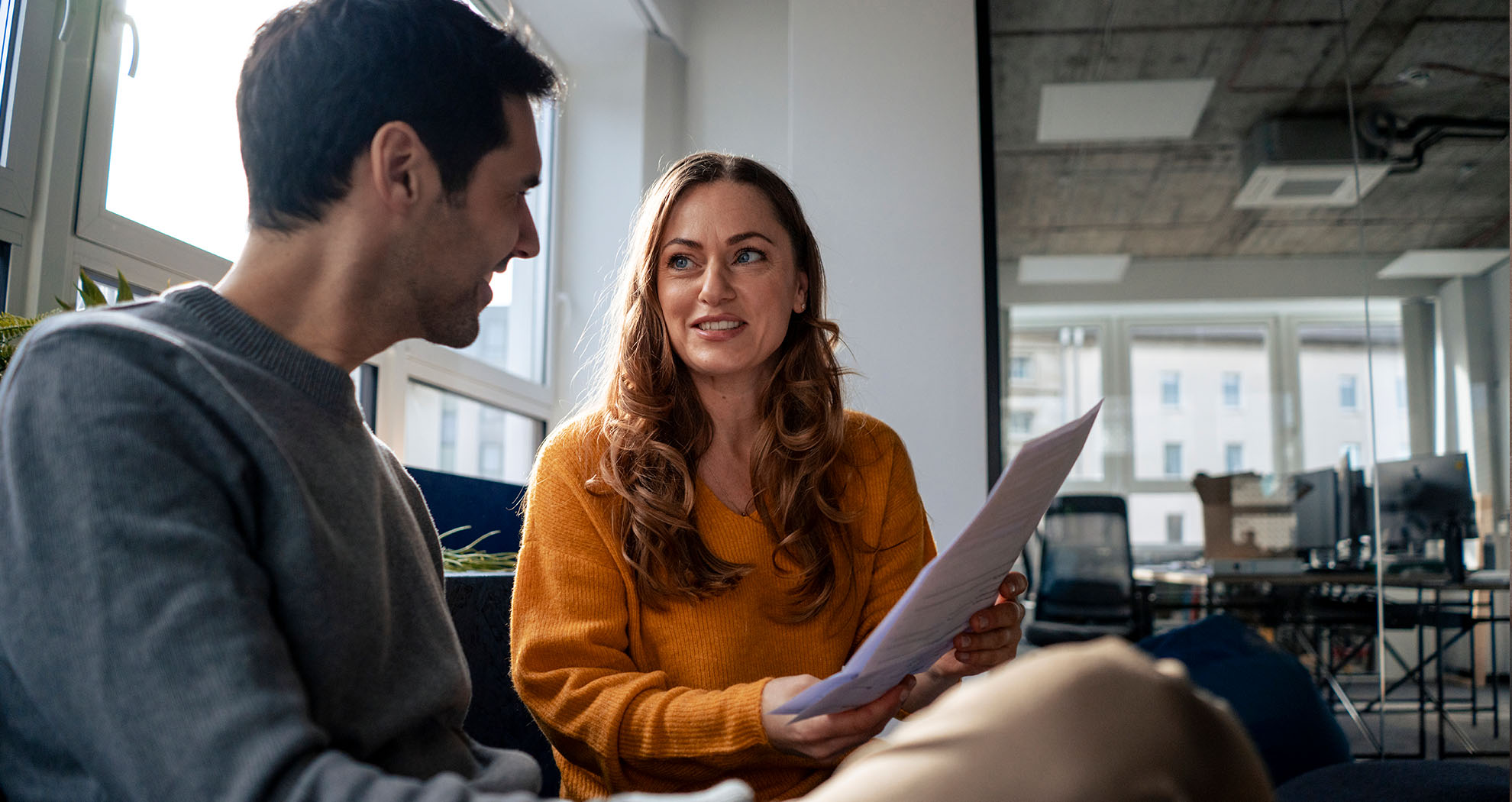 two office workers talking about communicating sustainability