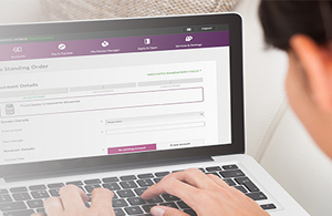 Lady using laptop to check internet banking